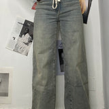 JEANS SABBIATO CON LACCIO